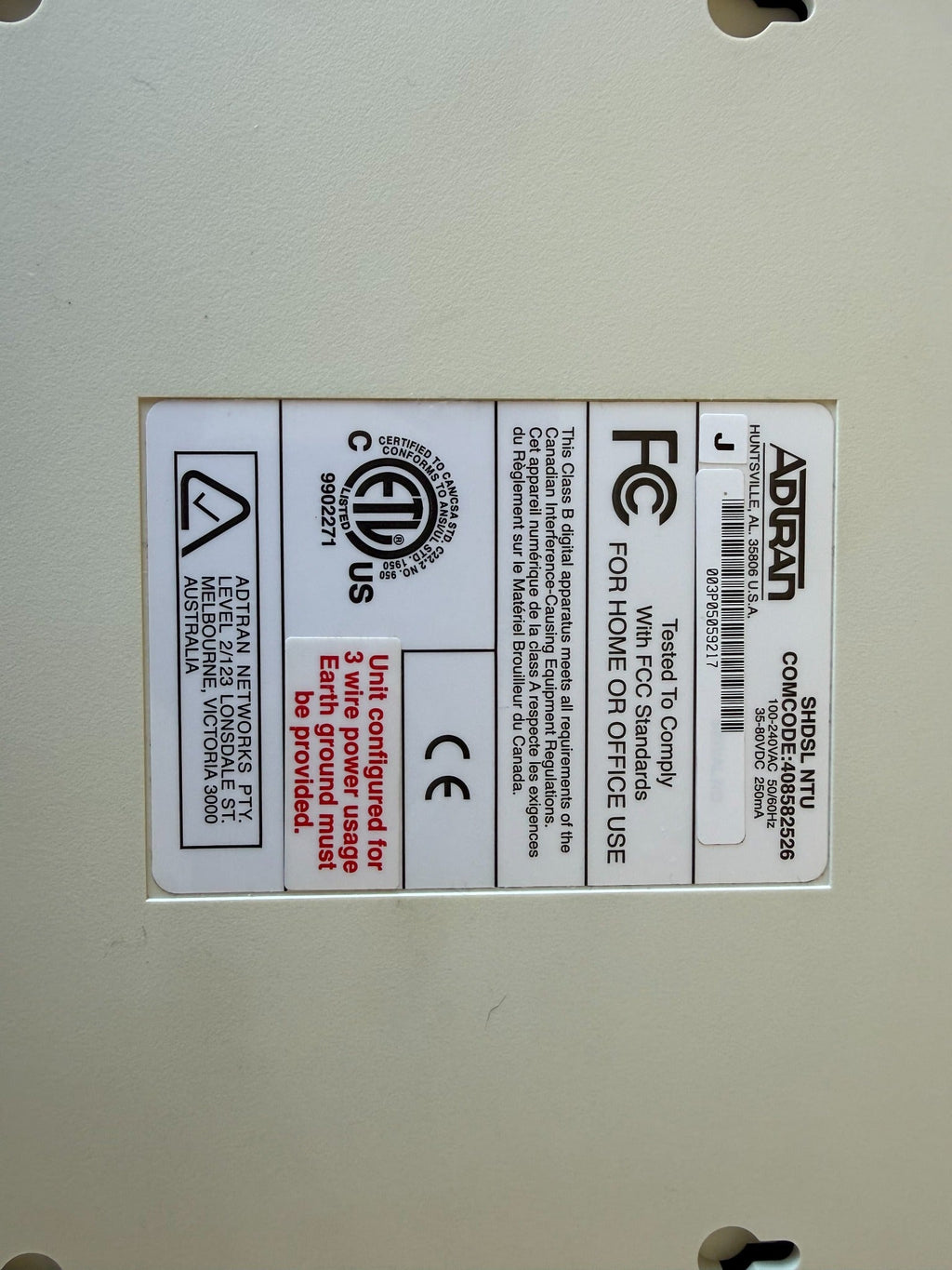 Original unedited underside label of the actual ADTRAN SHDSL NTU, showing COMCODE 408582526 and power ratings