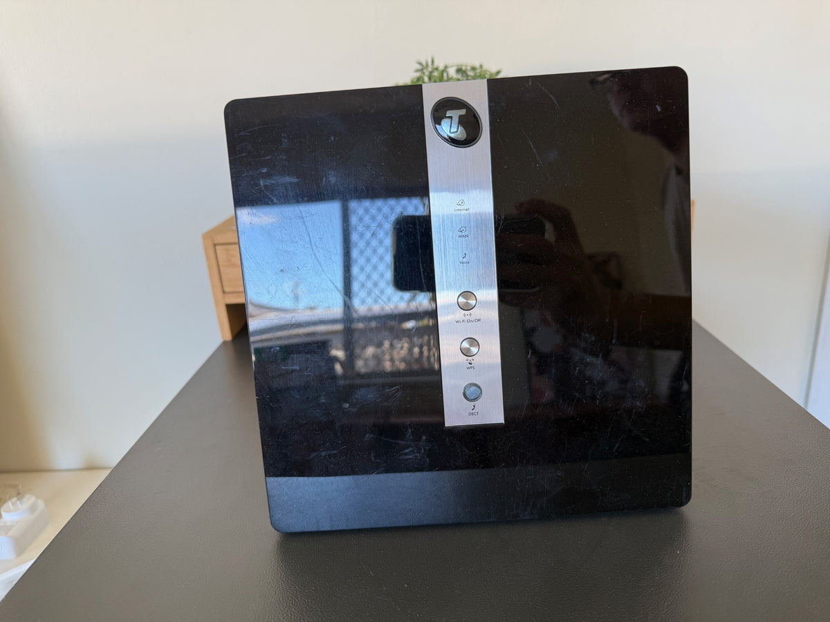 Actual used Netgear V7610 Telstra Business Smart Modem, black and silver with cosmetic scratches